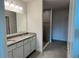 Bright bathroom with granite countertop, tiled floors, and tiled walk-in shower at 4152 Sagefield Dr, Harmony, FL 34773