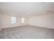 Large bonus room with neutral carpet and windows, offering ample space for entertaining at 4152 Sagefield Dr, Harmony, FL 34773