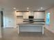 Bright kitchen featuring white cabinets, granite countertops, an island, and stainless steel appliances at 4152 Sagefield Dr, Harmony, FL 34773