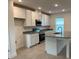 Modern kitchen with white cabinets, stainless steel appliances, granite countertops, and a center island at 4152 Sagefield Dr, Harmony, FL 34773