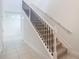 Carpeted staircase with white trim and black metal railing leading to the second floor at 4152 Sagefield Dr, Harmony, FL 34773