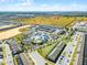 Wide aerial shot captures a community pool and recreation area surrounded by homes, landscaping, and parking spaces on a clear day at 4210 Lana Ave, Davenport, FL 33897