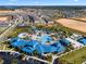 An expansive aerial view showcasing a community pool, parking, landscaping and surrounding neighborhood at 4210 Lana Ave, Davenport, FL 33897