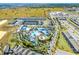 Overhead view showcases a community aquatic center with pools, landscaping, and nearby residential buildings, all under a bright sky at 4210 Lana Ave, Davenport, FL 33897