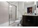 Neutral-toned bathroom featuring a glass-enclosed shower, toilet, and vanity with a granite countertop at 4210 Lana Ave, Davenport, FL 33897