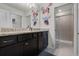 bathroom featuring a double vanity, Mickey Mouse decals, and glass-enclosed shower at 4210 Lana Ave, Davenport, FL 33897