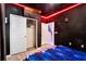 Themed bedroom showcasing a closet with white doors, a nebula-print bedset, and a wall with red light details at 4210 Lana Ave, Davenport, FL 33897