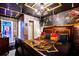 Themed bedroom boasting a brick accent wall, character art, and ceiling with dark wood trim at 4210 Lana Ave, Davenport, FL 33897