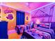 Whimsical Minions themed bedroom featuring playful decor, two beds, and neon lighting at 4210 Lana Ave, Davenport, FL 33897