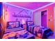 Playful Minions themed bedroom showcasing two twin beds, vibrant decor, and unique wall art at 4210 Lana Ave, Davenport, FL 33897