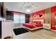 Mickey Mouse themed bedroom with red accent wall, modern lighting, and unique decor at 4210 Lana Ave, Davenport, FL 33897