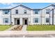 Charming two-story townhomes showcasing modern facades, manicured lawns, and inviting entrances at 4210 Lana Ave, Davenport, FL 33897