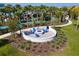 Outdoor community fire pit with seating, surrounded by lush landscaping and resort amenities at 4210 Lana Ave, Davenport, FL 33897