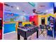 Bright, vibrant game room with a foosball table and wall-to-wall Super Mario Brothers themed artwork at 4210 Lana Ave, Davenport, FL 33897