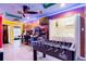 Game room features multiple arcade games, foosball, and laundry area with bright colors and fun themes at 4210 Lana Ave, Davenport, FL 33897