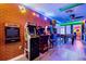 Arcade room with brick accent wall, a row of arcade games and a foosball table at 4210 Lana Ave, Davenport, FL 33897