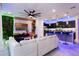 Contemporary living room with a white leather sectional, custom wall features, and an open layout to the kitchen at 4210 Lana Ave, Davenport, FL 33897