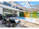 Inviting pool area with outdoor seating, a grill, and a charming decorative wooden privacy wall feature at 4210 Lana Ave, Davenport, FL 33897