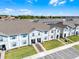 Street view of newly constructed townhomes featuring sidewalks and landscaping at 4210 Lana Ave, Davenport, FL 33897