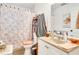 Cozy bathroom showcasing a seashell-themed shower curtain, cabinet sink, and a decorative mirror at 4482 Se 142Nd St, Summerfield, FL 34491
