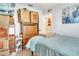 Bright bedroom featuring light blue bedding and a classic wooden dresser with ample storage at 4482 Se 142Nd St, Summerfield, FL 34491