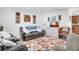 Cozy living room features comfortable seating, a floral rug, and decorative wall art at 4482 Se 142Nd St, Summerfield, FL 34491