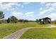 Backyard featuring green grass, gazebo, and tranquil water views creates a relaxing outdoor space at 4672 Marina Row Dr, Orlando, FL 32820