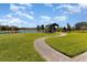 Backyard with lush green grass, gazebo, and serene water views offers a peaceful retreat at 4672 Marina Row Dr, Orlando, FL 32820