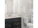 Bathroom featuring a dark vanity, a white toilet, and a shower with a decorative shower curtain at 4672 Marina Row Dr, Orlando, FL 32820