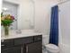 Bathroom featuring a dark vanity, a white toilet, and a shower with a blue shower curtain at 4672 Marina Row Dr, Orlando, FL 32820