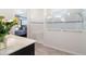 Bathroom featuring white tiled shower, frameless glass and a shower bench at 4672 Marina Row Dr, Orlando, FL 32820