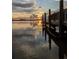 Picturesque waterfront view from a wooden dock at sunset, showcasing serene water reflections at 4672 Marina Row Dr, Orlando, FL 32820