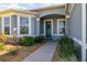 Charming front entrance featuring a decorative wreath and lush landscaping enhancing curb appeal at 4672 Marina Row Dr, Orlando, FL 32820
