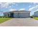 Charming single-story home featuring a brick driveway, neutral paint, manicured lawn, and two-car garage at 4672 Marina Row Dr, Orlando, FL 32820