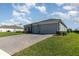 Attractive home with a brick driveway, well-maintained landscaping, and a spacious two-car garage at 4672 Marina Row Dr, Orlando, FL 32820