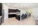 Spacious kitchen featuring a large island, dark cabinetry, and a modern design at 4672 Marina Row Dr, Orlando, FL 32820