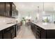 Modern kitchen features stainless steel appliances, tile backsplash and a center island with sink at 4672 Marina Row Dr, Orlando, FL 32820