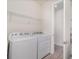 Laundry room featuring a modern washer and dryer, a wire shelf, and light grey wood-look floors at 4672 Marina Row Dr, Orlando, FL 32820