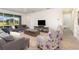 Bright and airy living room boasts ample natural light and views of the outdoor space at 4672 Marina Row Dr, Orlando, FL 32820