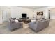 Inviting living room featuring wood-look tile floors, comfortable seating, and stylish decor at 4672 Marina Row Dr, Orlando, FL 32820