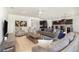 Open-concept living room featuring a comfortable sofa, armchairs, tile floors, and modern decor at 4672 Marina Row Dr, Orlando, FL 32820