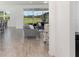 Bright living space with wood-look flooring, a large window view of the back yard, and comfortable seating at 4672 Marina Row Dr, Orlando, FL 32820