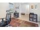 Office with desk, shelves, and patterned rug, and light grey wood-look floors at 4672 Marina Row Dr, Orlando, FL 32820