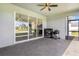 Outdoor patio with brick pavers, outdoor kitchen, and a view into the home's kitchen at 4672 Marina Row Dr, Orlando, FL 32820
