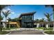Modern building exterior featuring expansive glass windows, palm trees and manicured landscaping at 4741 Cloister St, Kissimmee, FL 34758