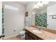 Bathroom with granite vanity, and tiled shower at 475 Pitt St, Clermont, FL 34711