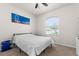 Bright bedroom with a full bed, a window view, and vibrant wall art at 475 Pitt St, Clermont, FL 34711