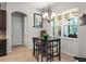 Cozy dining area with a chandelier, views of the outdoor space, and access to the kitchen at 475 Pitt St, Clermont, FL 34711