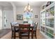 A dining room with a dark wood table, adjacent to a shelving unit, next to the entryway at 475 Pitt St, Clermont, FL 34711