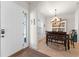 Bright entryway with sidelight window leading to dining area with chandelier and built-in shelving at 475 Pitt St, Clermont, FL 34711